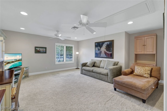 carpeted living room with ceiling fan