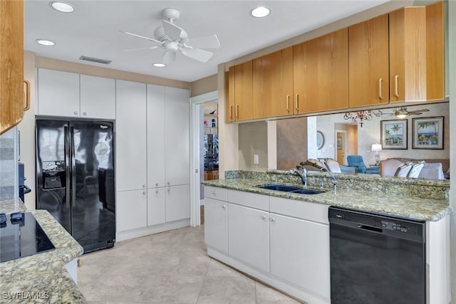 kitchen featuring sink, white cabinetry, light stone counters, ceiling fan, and black appliances