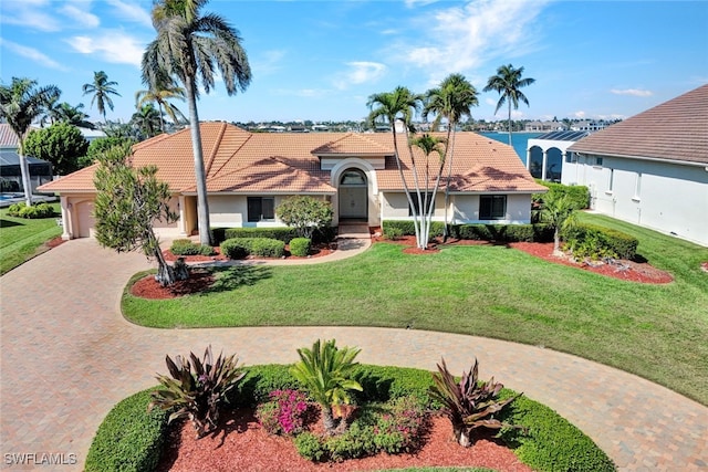 view of front of property with a garage and a front lawn