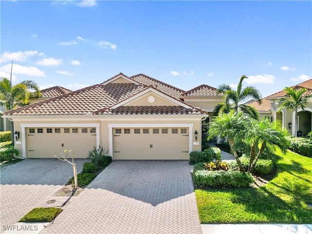 mediterranean / spanish-style house with a garage