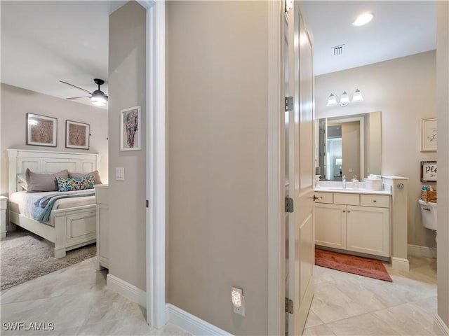 bathroom with vanity, toilet, and ceiling fan