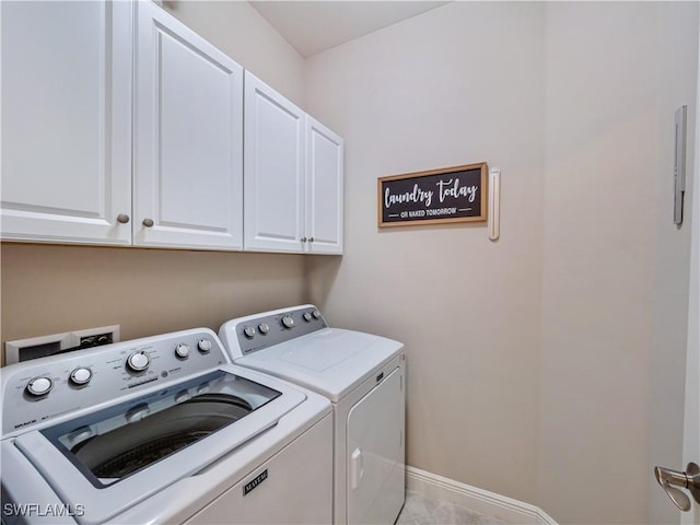 washroom featuring cabinets and washing machine and dryer