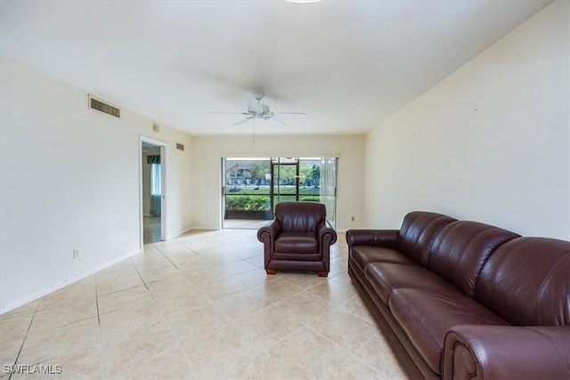 tiled living room with ceiling fan