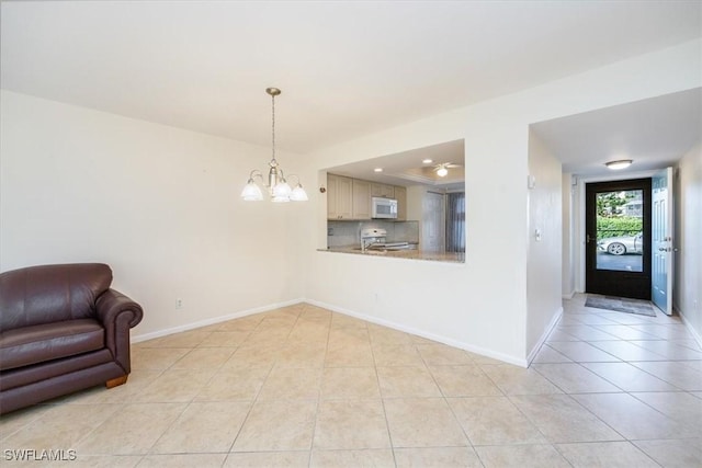 interior space featuring light tile patterned floors and a notable chandelier