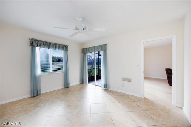 unfurnished room with light tile patterned floors and ceiling fan