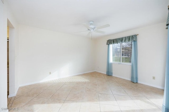 tiled spare room with ceiling fan