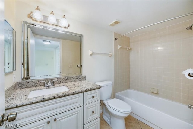 full bathroom with vanity, toilet, tiled shower / bath combo, and tile patterned flooring