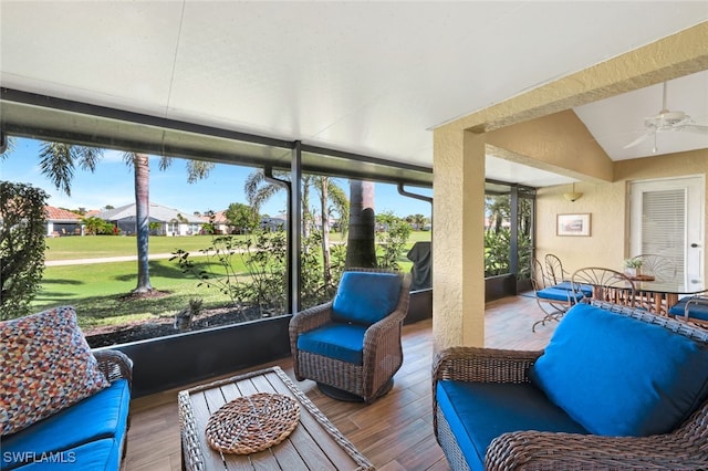 sunroom featuring vaulted ceiling and ceiling fan