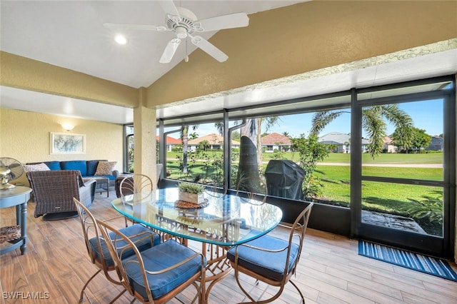 sunroom with lofted ceiling and ceiling fan