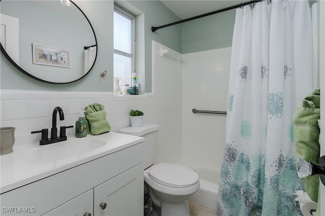 bathroom with vanity, tile walls, curtained shower, and toilet