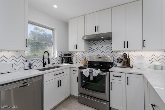 kitchen featuring sink, extractor fan, white cabinetry, stainless steel appliances, and backsplash