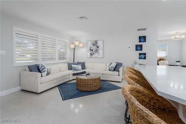 living room with an inviting chandelier