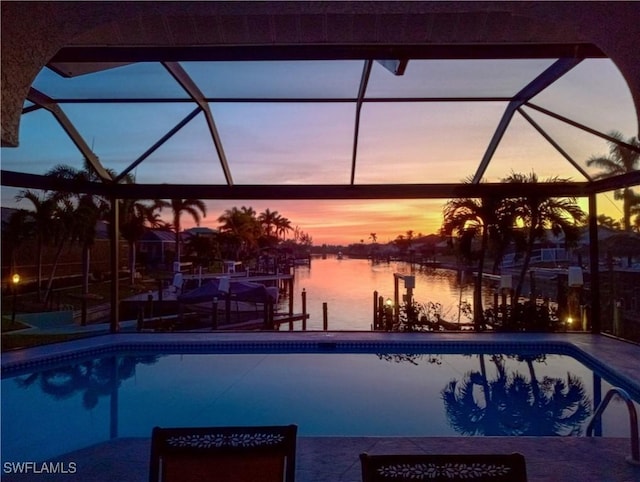 pool at dusk featuring a water view and glass enclosure