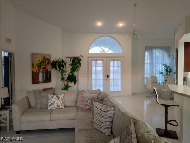 living room with french doors, ceiling fan, and tile patterned flooring