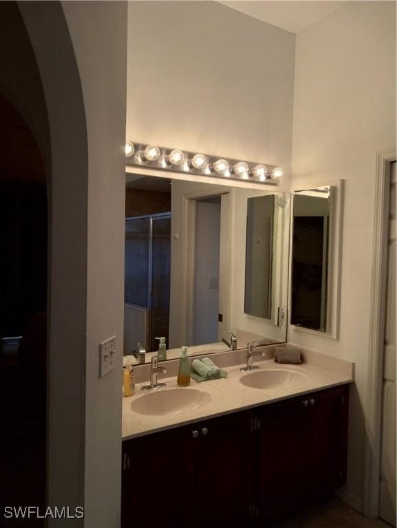 bathroom with vanity and a shower with shower door