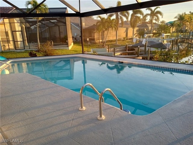 pool at dusk featuring glass enclosure