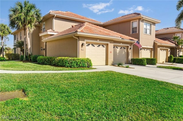 mediterranean / spanish house with a garage and a front yard