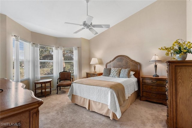 carpeted bedroom with ceiling fan and lofted ceiling