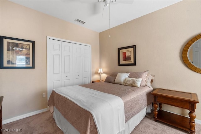 carpeted bedroom featuring ceiling fan and a closet