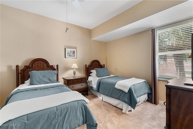 bedroom featuring light colored carpet and ceiling fan