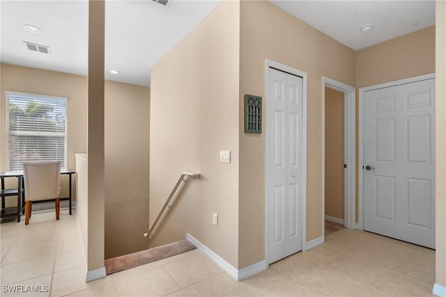 corridor featuring light tile patterned floors