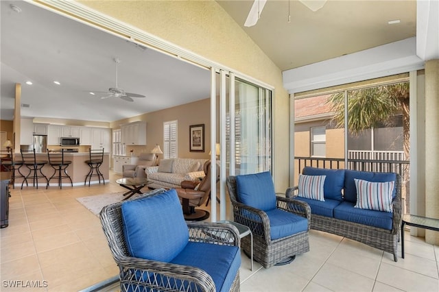 living room featuring light tile patterned flooring, lofted ceiling, and ceiling fan