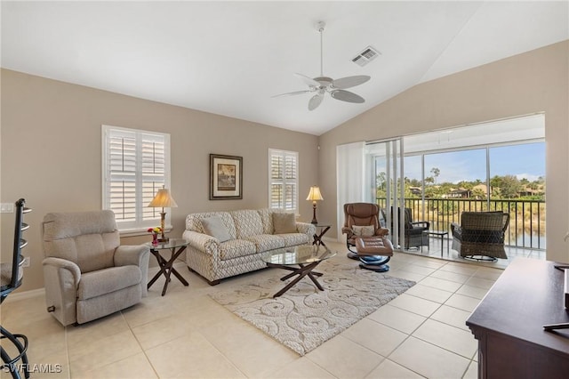 tiled living room with lofted ceiling and ceiling fan