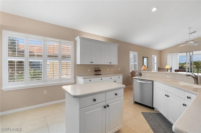 kitchen featuring lofted ceiling, sink, dishwasher, a wealth of natural light, and white cabinets