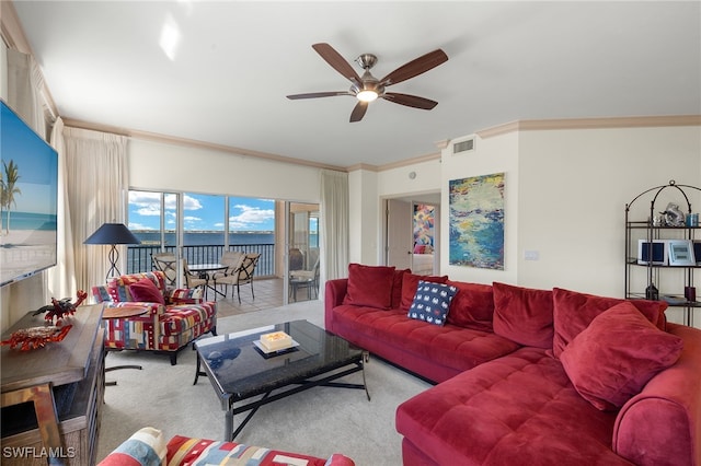 carpeted living room with crown molding and ceiling fan