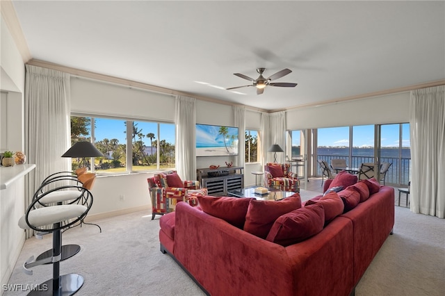 carpeted living room with crown molding and ceiling fan