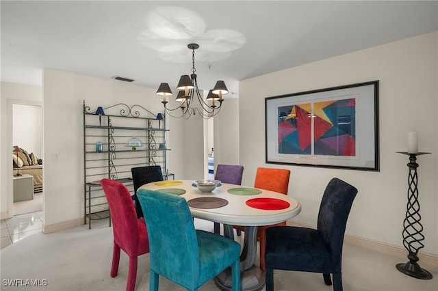 carpeted dining area with a notable chandelier