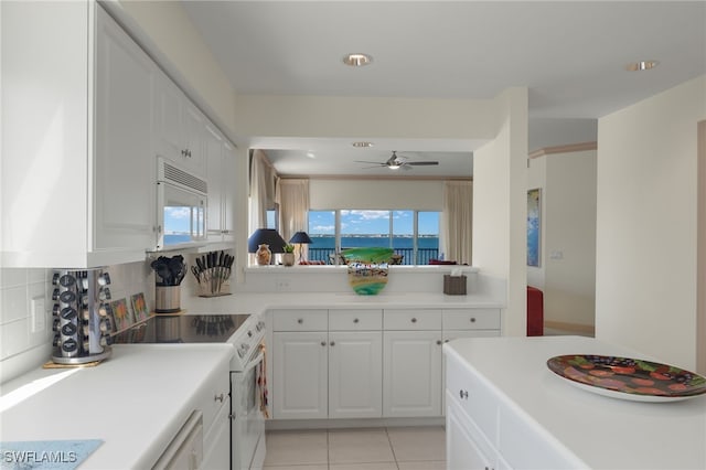 kitchen featuring white cabinetry, white appliances, tasteful backsplash, and a wealth of natural light