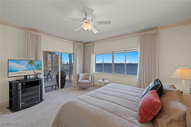 carpeted bedroom with access to outside, ornamental molding, ceiling fan, and a water view