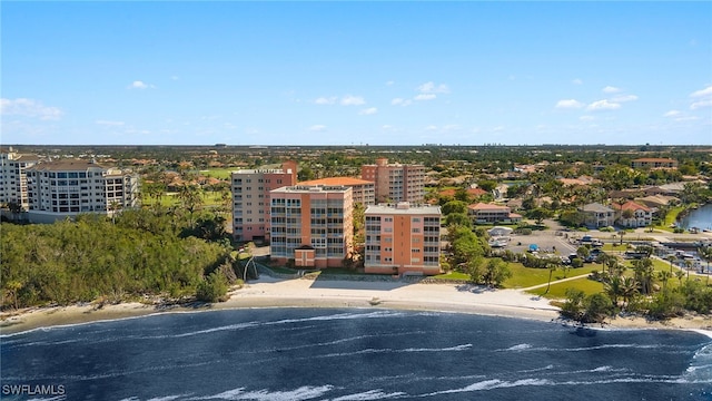 birds eye view of property with a water view and a beach view