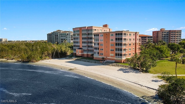 view of property featuring a water view and a beach view