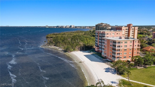 birds eye view of property with a beach view and a water view