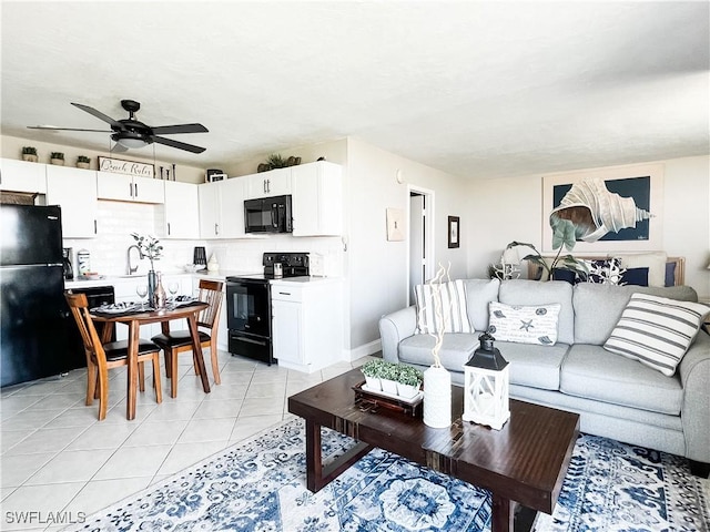 tiled living room featuring ceiling fan and sink