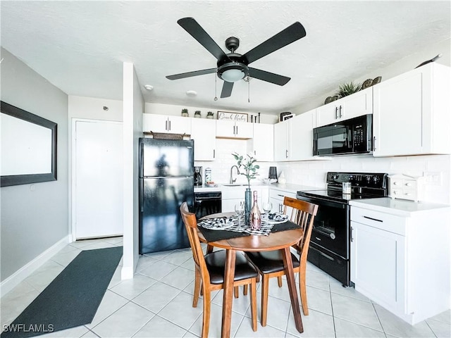 kitchen featuring tasteful backsplash, white cabinets, sink, and black appliances