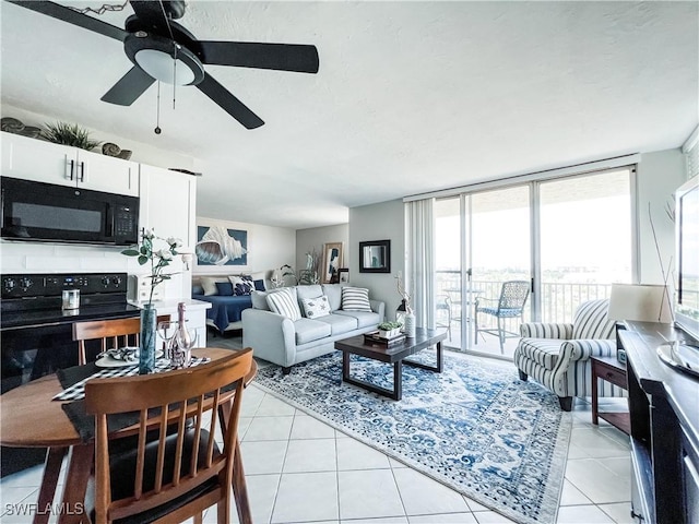 living room with ceiling fan, light tile patterned floors, and a wall of windows