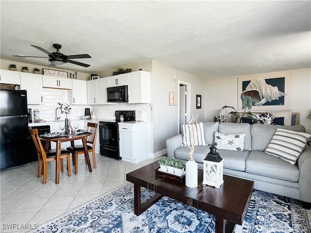 tiled living room with sink, a textured ceiling, and ceiling fan