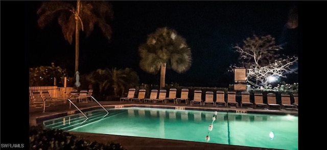 view of pool at night