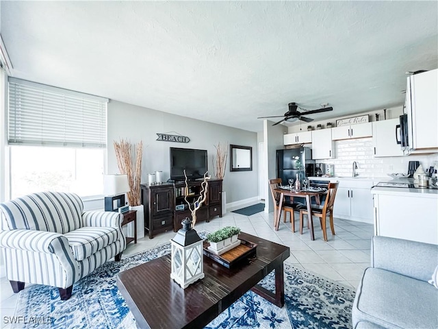 tiled living room with sink and ceiling fan