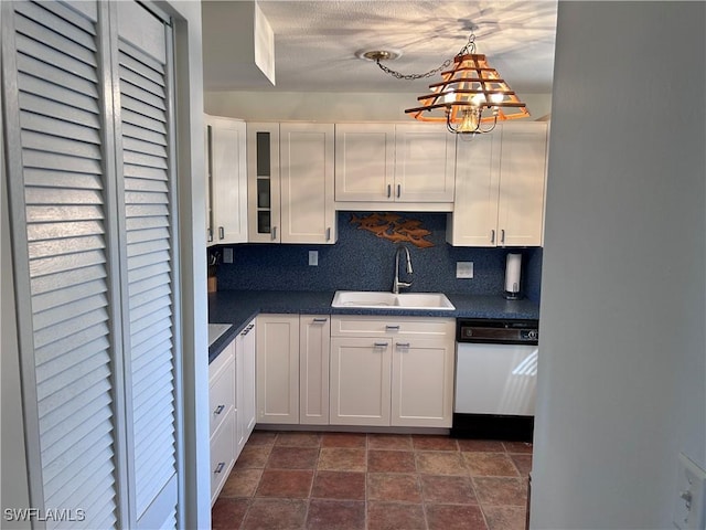 kitchen with tasteful backsplash, dishwasher, sink, white cabinets, and hanging light fixtures