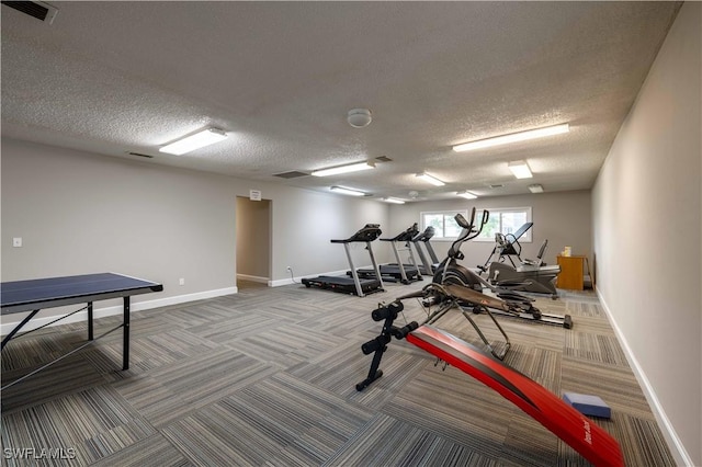 workout area with carpet flooring and a textured ceiling