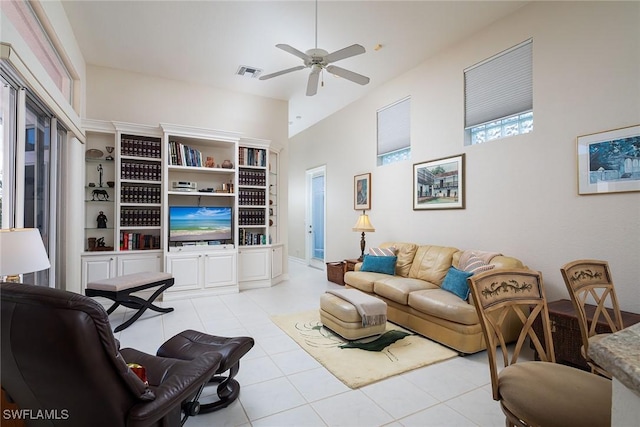 living room with ceiling fan and light tile patterned flooring