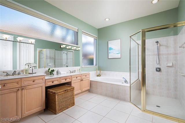 bathroom featuring tile patterned floors, vanity, and shower with separate bathtub