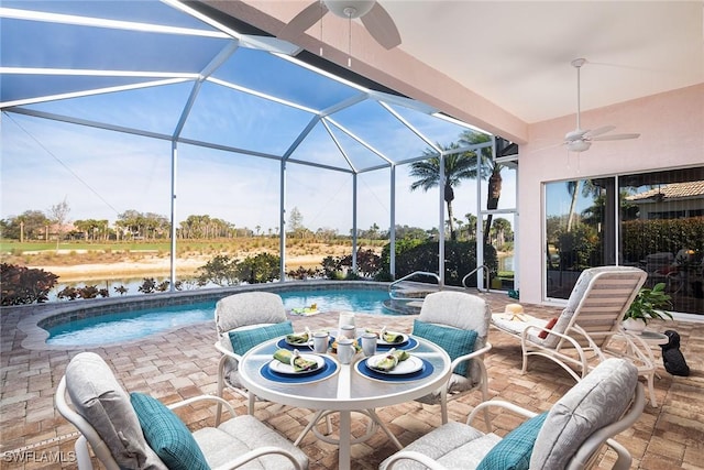 view of patio / terrace featuring ceiling fan and glass enclosure