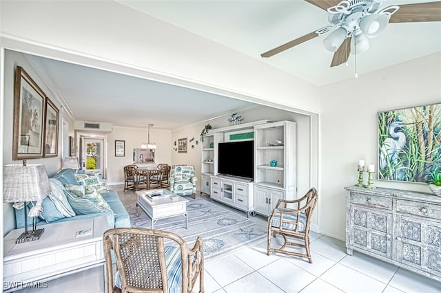 living room with crown molding, ceiling fan, and light tile patterned floors