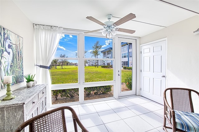 sunroom / solarium with a wealth of natural light and ceiling fan