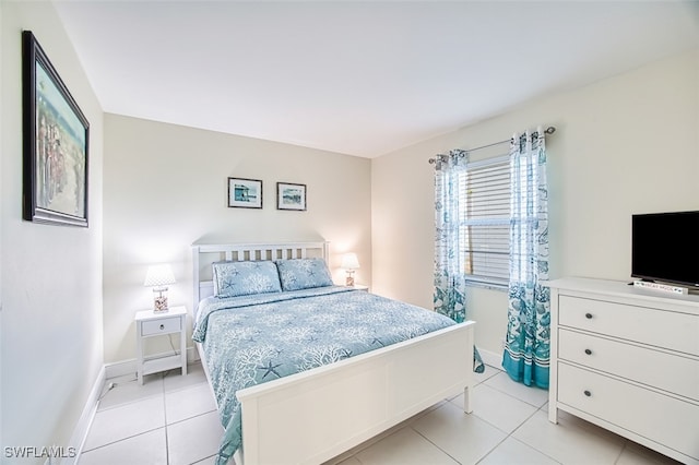 bedroom with light tile patterned floors